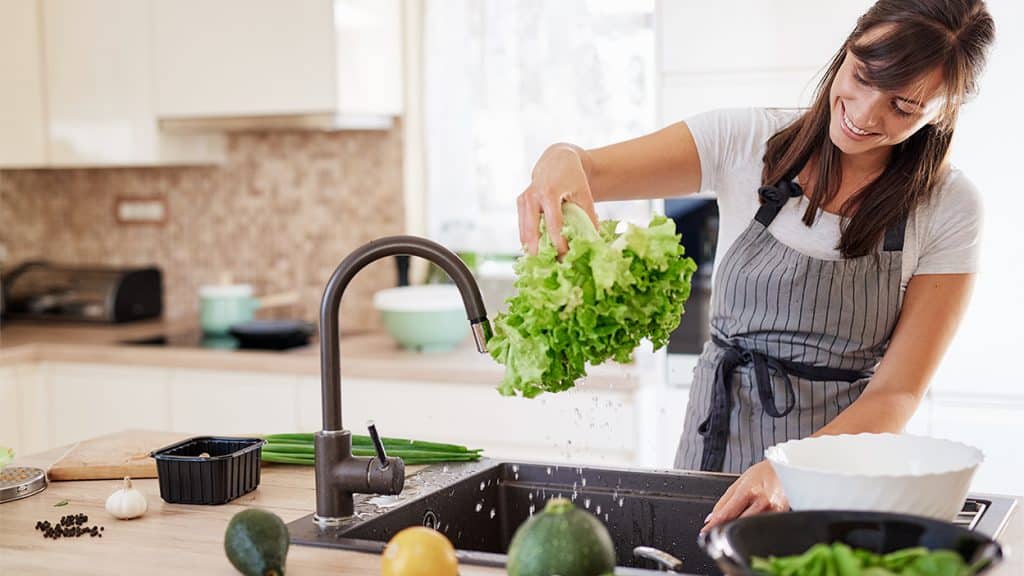 woman washing vegetables